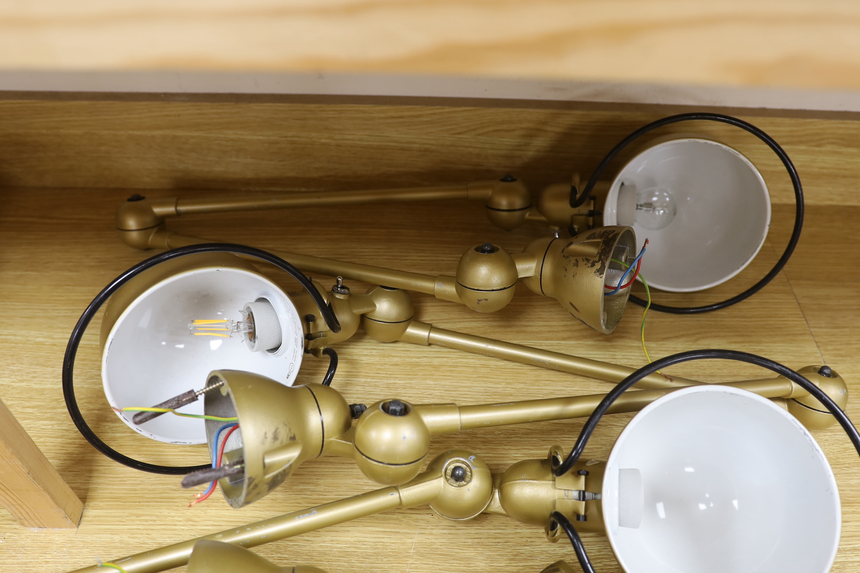 Set of four gilt painted anglepoise lamps, 117cm in length when extended